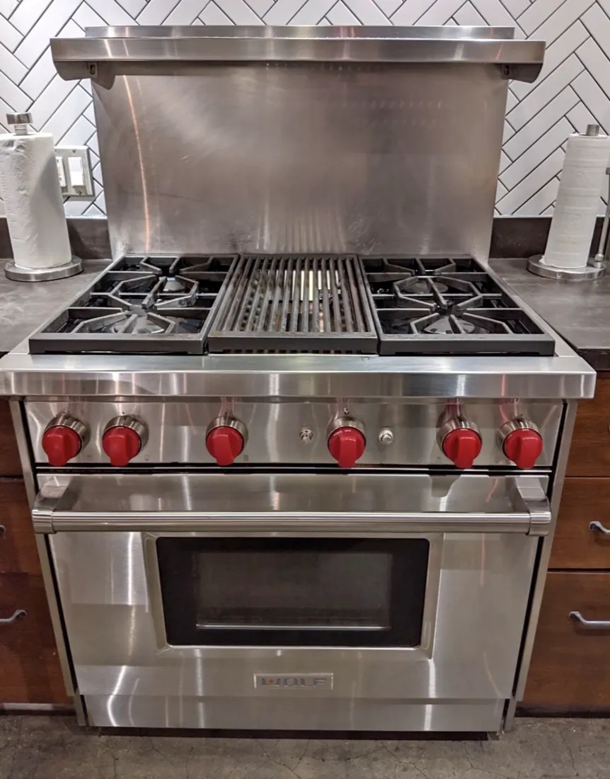 Wolf gas range with red knobs serviced in San Diego